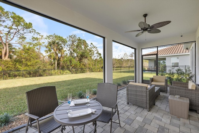 sunroom featuring ceiling fan