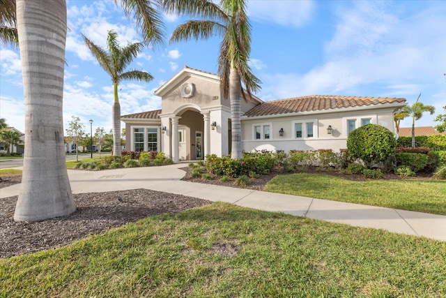 mediterranean / spanish home featuring a front yard