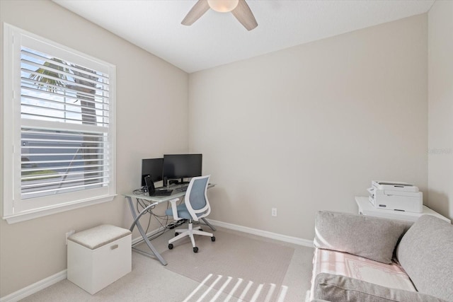 carpeted office featuring ceiling fan