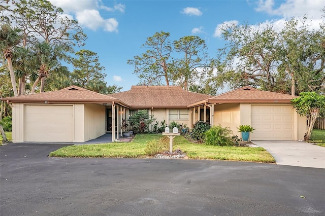 ranch-style house with a garage and a front lawn