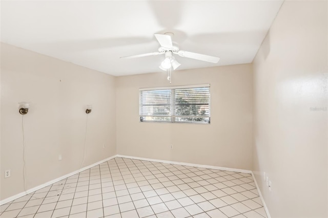 tiled spare room with ceiling fan