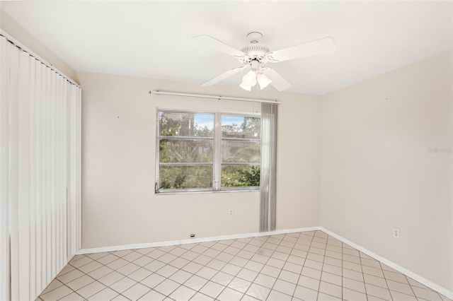 tiled spare room with ceiling fan