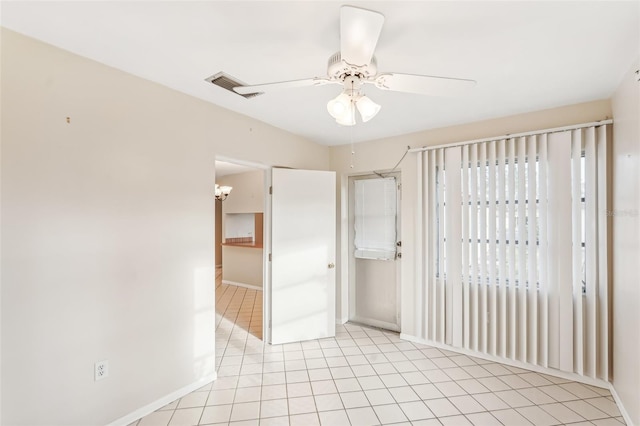 tiled empty room with ceiling fan