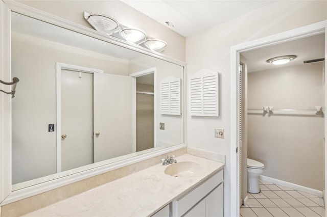 bathroom featuring tile patterned flooring, vanity, and toilet