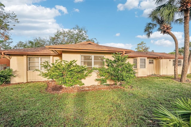 rear view of property with a lawn