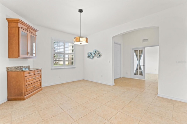 unfurnished dining area featuring light tile patterned floors