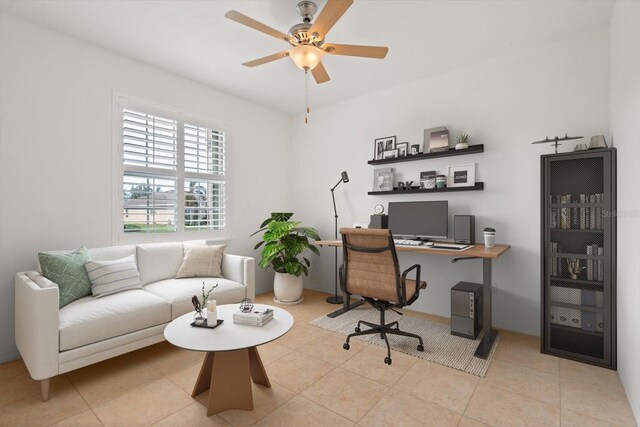 tiled home office featuring ceiling fan