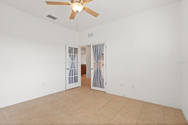 unfurnished room featuring french doors and ceiling fan