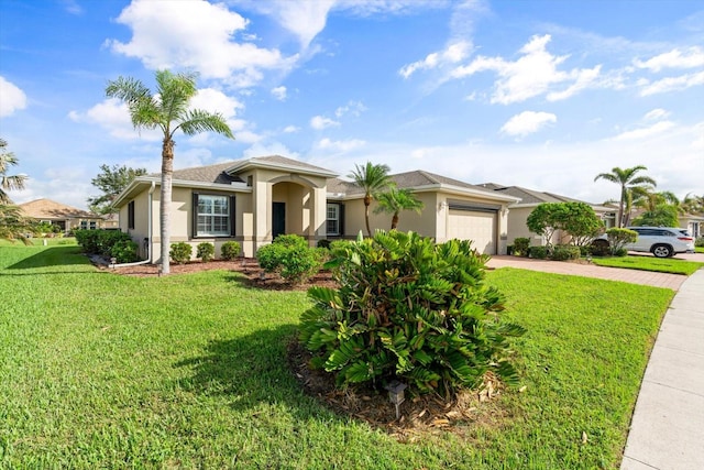 view of front of property with a front yard and a garage