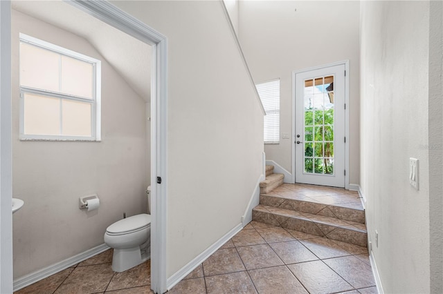 interior space with tile patterned floors and toilet