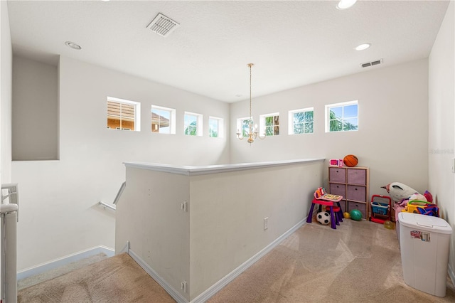 playroom with light colored carpet and an inviting chandelier