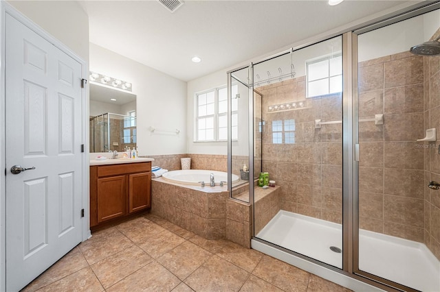 bathroom featuring tile patterned floors, vanity, and separate shower and tub