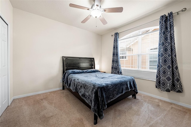 bedroom featuring light carpet and ceiling fan