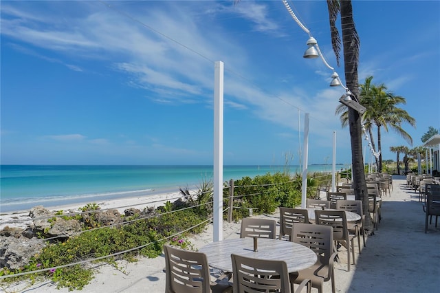 view of patio / terrace featuring a view of the beach and a water view