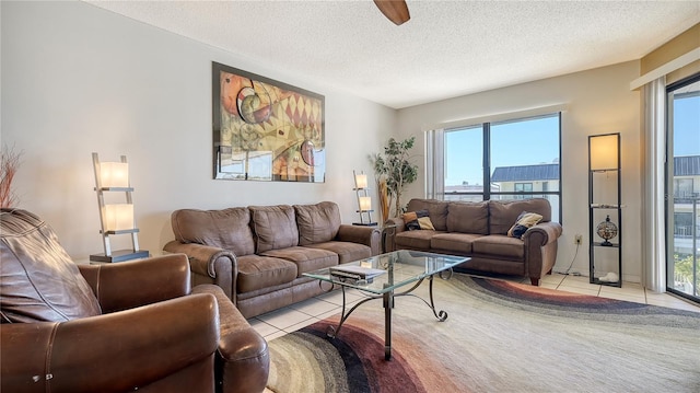 living area with light tile patterned floors and a textured ceiling