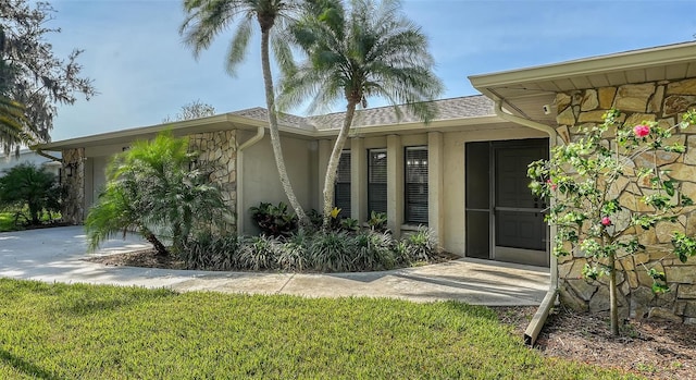 property entrance with a yard