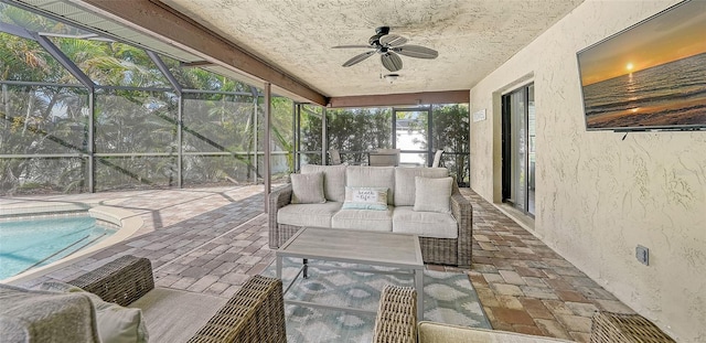 sunroom featuring ceiling fan and a swimming pool