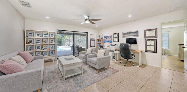 office featuring ceiling fan, light tile patterned floors, and a textured ceiling