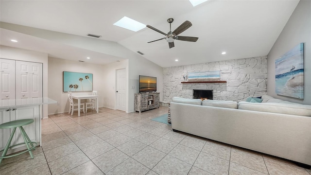 unfurnished living room featuring a fireplace, light tile patterned floors, ceiling fan, and lofted ceiling