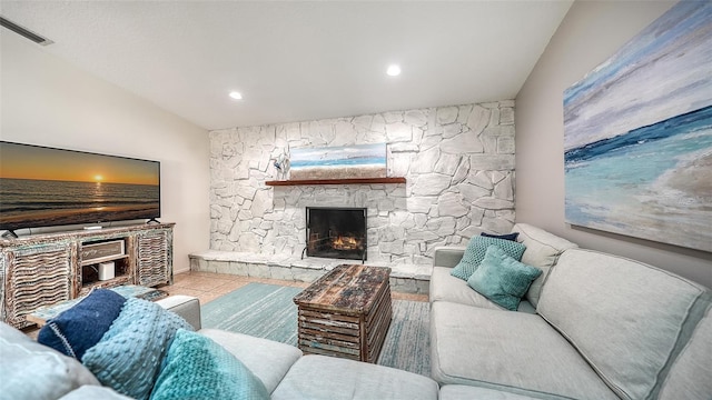 living room with a fireplace, light tile patterned floors, and lofted ceiling