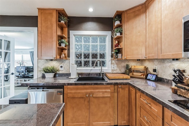 kitchen featuring stainless steel dishwasher, decorative backsplash, and sink