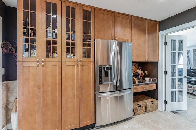 kitchen featuring light tile patterned flooring and stainless steel refrigerator with ice dispenser