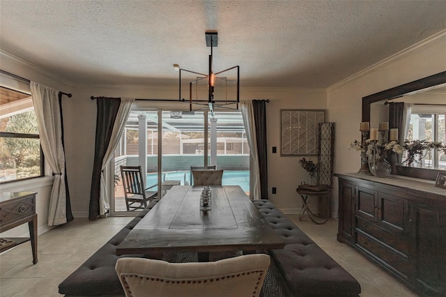 dining room featuring a textured ceiling, light tile patterned flooring, crown molding, and a chandelier