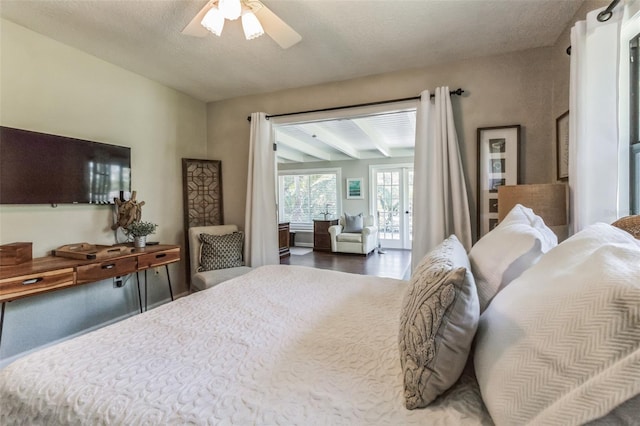 bedroom featuring ceiling fan, wood-type flooring, and a textured ceiling