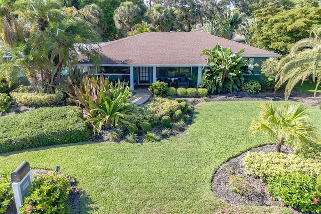 ranch-style home with a front lawn