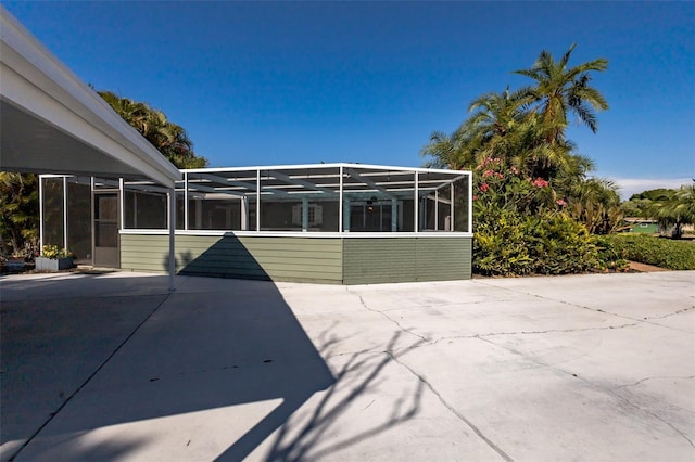 back of property featuring a patio area and a lanai