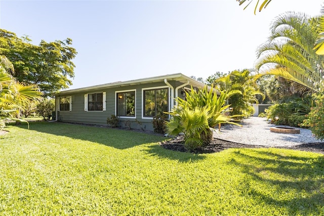 rear view of house with a yard