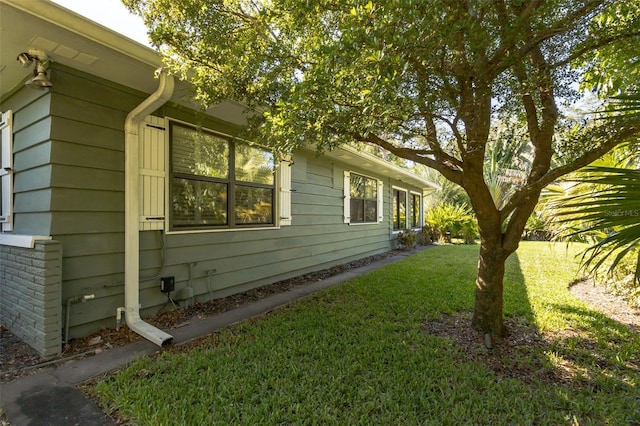 view of property exterior with a yard