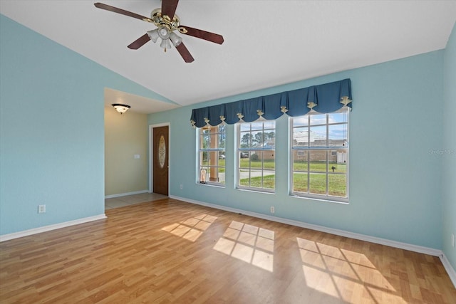 unfurnished room featuring hardwood / wood-style flooring, vaulted ceiling, and ceiling fan