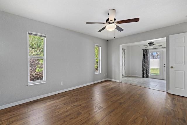 empty room featuring ceiling fan and dark wood-type flooring