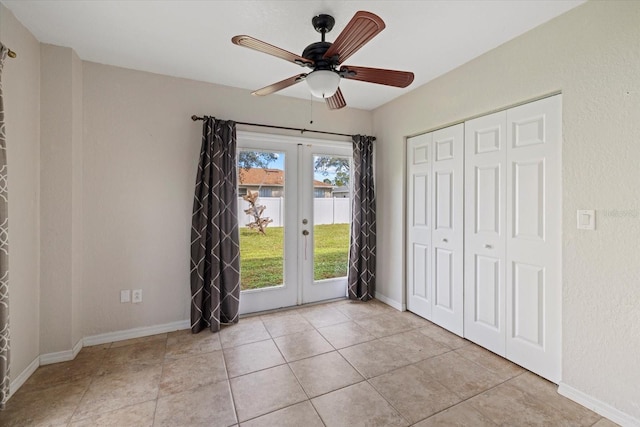 unfurnished bedroom featuring french doors, a closet, ceiling fan, and light tile patterned flooring