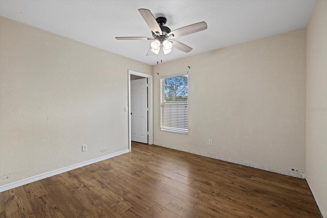 empty room featuring ceiling fan and dark hardwood / wood-style floors