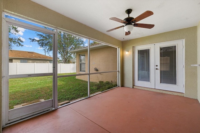 unfurnished sunroom with ceiling fan and french doors