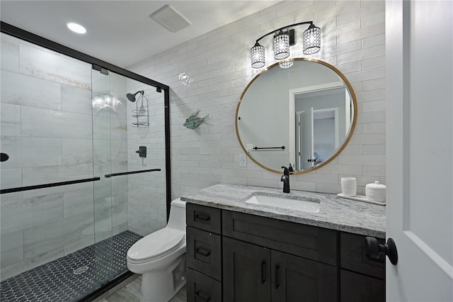 bathroom featuring vanity, decorative backsplash, toilet, tile walls, and an enclosed shower