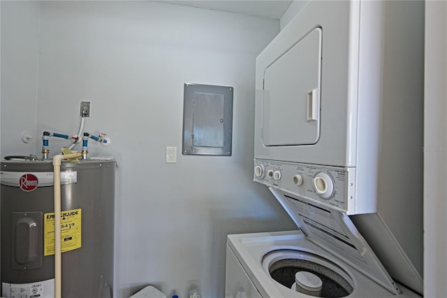 clothes washing area featuring stacked washing maching and dryer, electric panel, and water heater