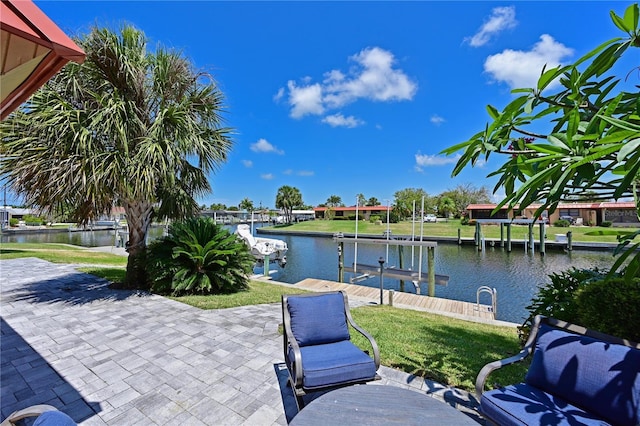 view of patio with a water view and a dock