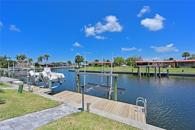 dock area with a water view and a yard