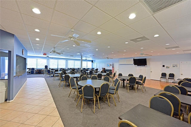 dining space featuring a paneled ceiling, ceiling fan, and light tile patterned flooring