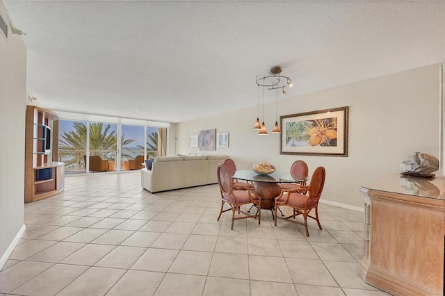 1800 Benjamin Franklin Dr Unit A304, Sarasota, FL 34236 - dining room featuring baseboards, light tile patterned floors, a textured ceiling, and a wall of windows