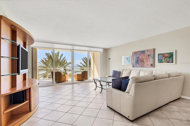 1800 Benjamin Franklin Dr Unit A304, Sarasota, FL 34236 - living room with a textured ceiling and light tile patterned flooring