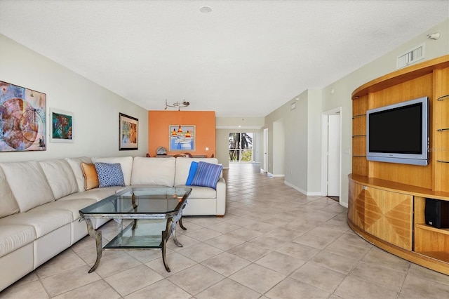 1800 Benjamin Franklin Dr Unit A304, Sarasota, FL 34236 - living area featuring light tile patterned floors, baseboards, and a textured ceiling