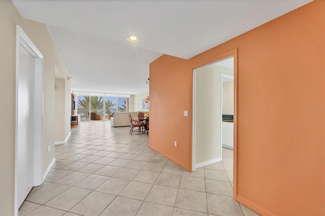 1800 Benjamin Franklin Dr Unit A304, Sarasota, FL 34236 - hall with baseboards, light tile patterned floors, and recessed lighting