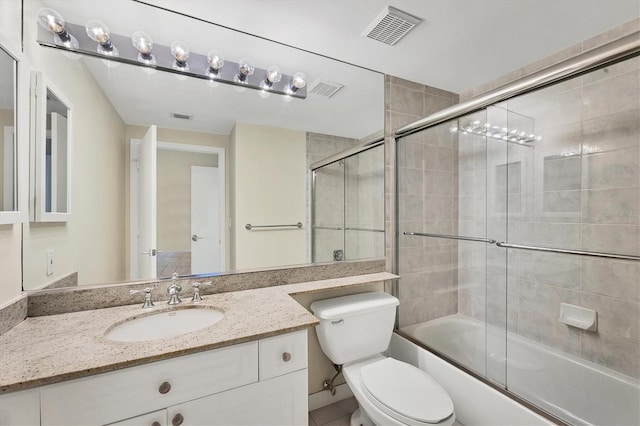 1800 Benjamin Franklin Dr Unit A304, Sarasota, FL 34236 - bathroom featuring toilet, vanity, and bath / shower combo with glass door