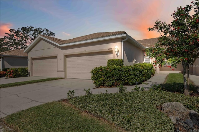 4209 Cascade Falls Dr, Sarasota, FL 34243 - single story home featuring concrete driveway, stucco siding, an attached garage, and a tiled roof