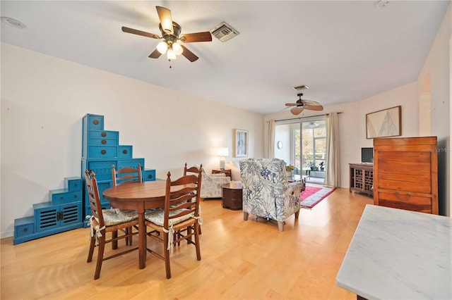 dining area with hardwood / wood-style flooring and ceiling fan