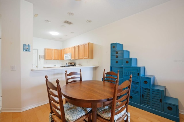 4209 Cascade Falls Dr, Sarasota, FL 34243 - dining room with baseboards and light wood-style floors